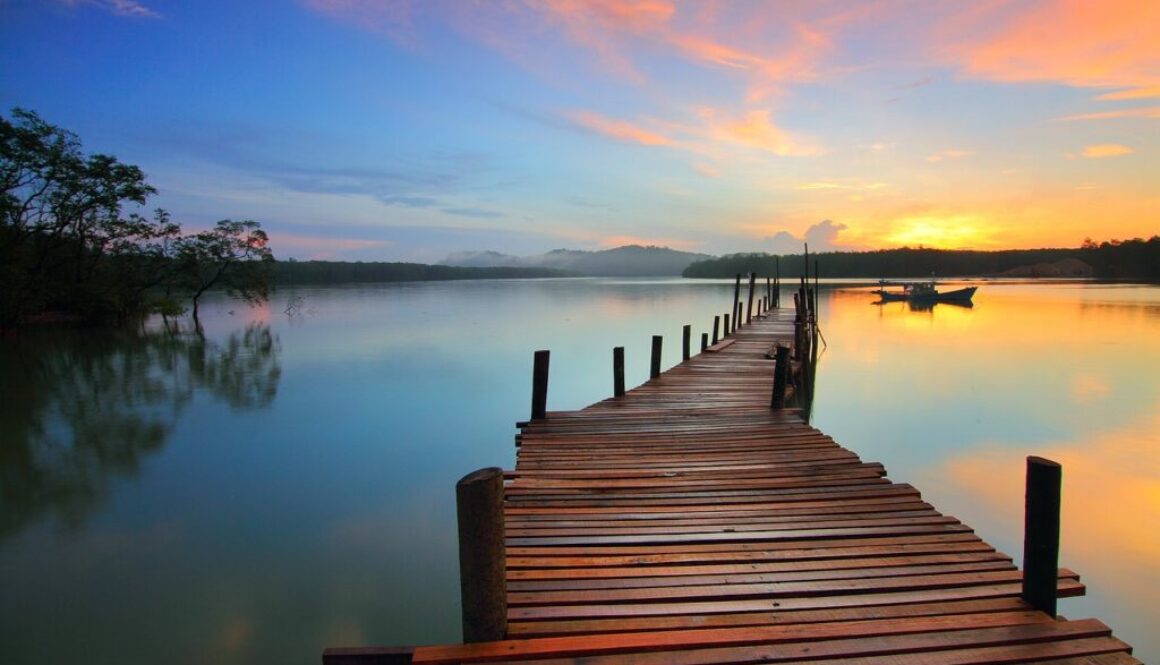 a wooden pier going out into a lake representing retirement